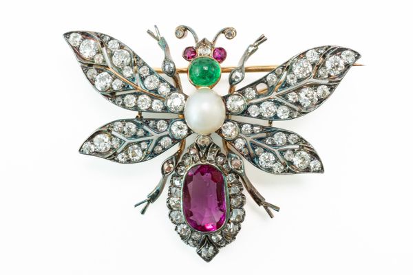 A GOLD BACKED AND SILVER SET, GEMSET, WINGED INSECT BROOCH