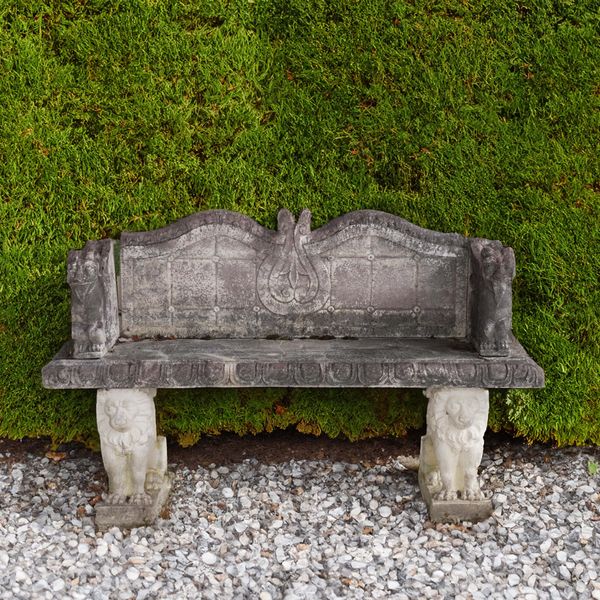 A CARVED RECONSTITUTED  STONE BENCH