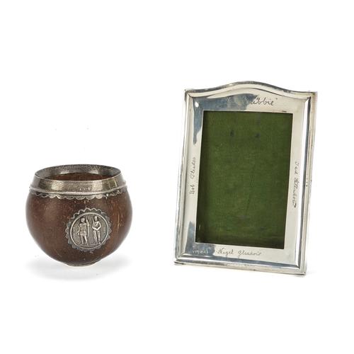A SILVER MOUNTED PHOTOGRPAH FRAME AND A SILVER MOUNTED COCONUT BOWL (2)