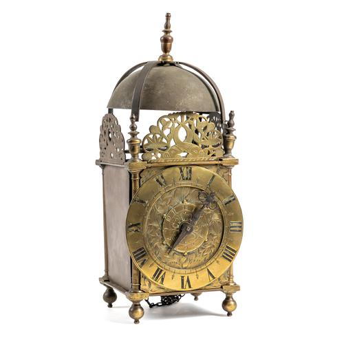 A BRASS BALANCE WHEEL STRIKING LANTERN CLOCK