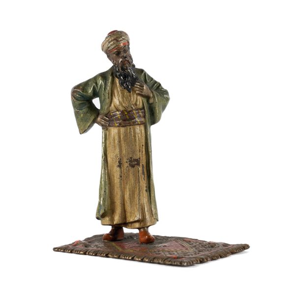 PROBABLY FRANZ XAVER BERGMANN, AN EARLY 20TH CENTURY COLD PAINTED BRONZE FIGURE OF A MAN STANDING ON A CARPET