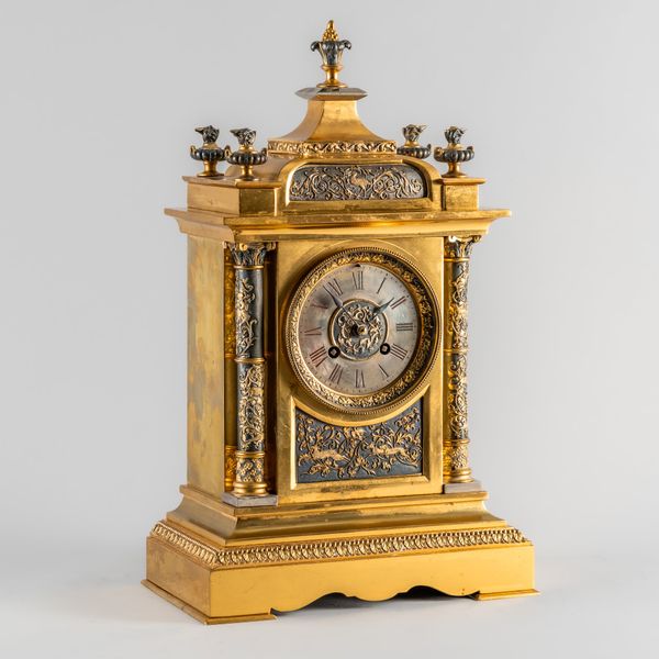 A FRENCH GILT METAL AND PATINATED MANTEL CLOCK