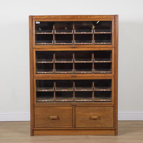 F. SAGE AND CO LTD LONDON; A MID 20TH CENTURY OAK HABERDASHERY CABINET