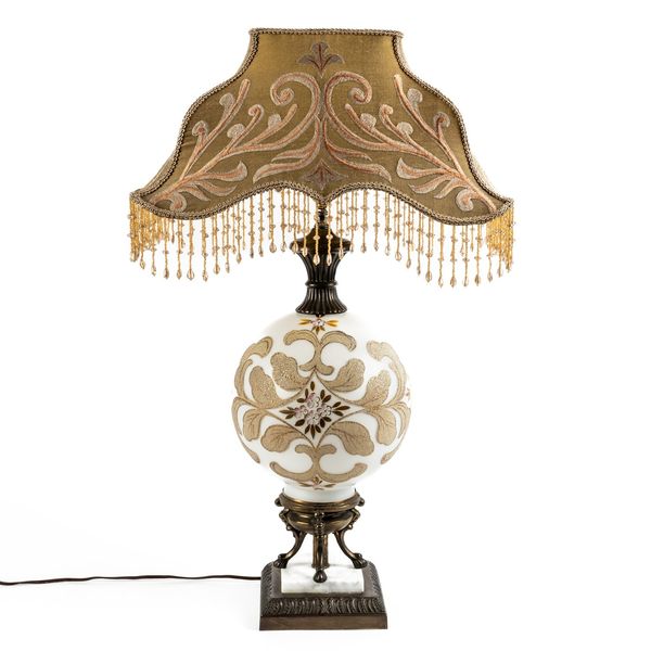 AN IVORY GROUND METAL AND CERAMIC GLOBULAR TABLE LAMP