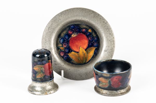 A MOORCROFT PEWTER MOUNTED SALT, PEPPER AND SMALL PLATE (3)