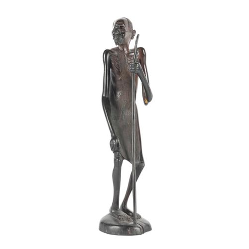 ***CMB with line 15*** OF TRIBAL INTEREST: AN EBONISED CARVED WOODEN FIGURE OF AN AFRICAN MAN