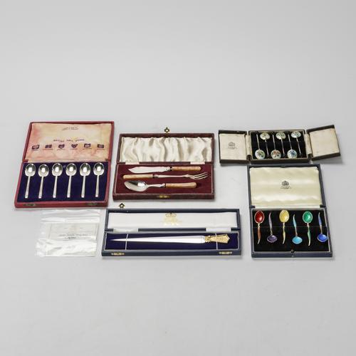 A SILVER AND GILT PAPER KNIFE AND THREE CASED SETS OF SIX SILVER SPOONS AND ANOTHER SET (5)