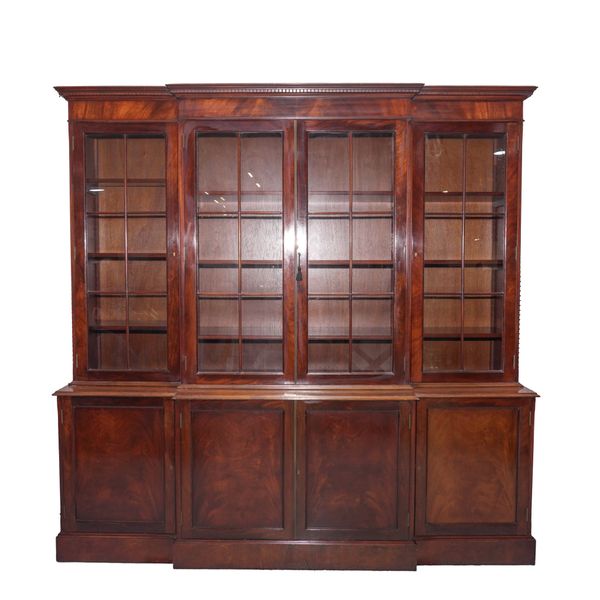 A GEORGE III STYLE MAHOGANY BREAKFRONT BOOKCASE CABINET
