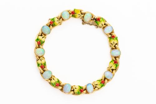 ATTRIBUTED TO MRS NEWMAN: A GOLD, OPAL AND ENAMEL BRACELET