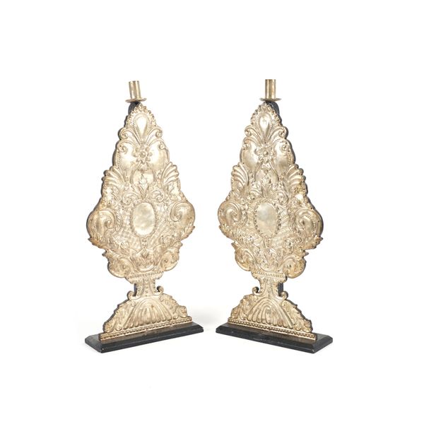 A PAIR OF CONTINENTAL EMBOSSED SILVERED METAL ALTAR CANDLESTICKS (2)