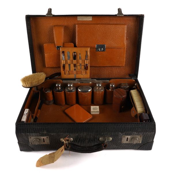 AN AUSTRIAN LEATHER VANITY CASE WITH FITTED INTERIOR