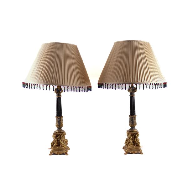 A PAIR OF BLACK AND GILT METAL CORINTHIAN COLUMN TABLE LAMPS (2)