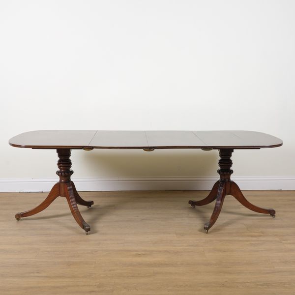 A WILLIAM IV MAHOGANY TWIN PILLAR DINING TABLE