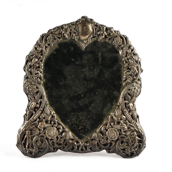 A LATE VICTORIAN SILVER MOUNTED HEART SHAPED TABLE MIRROR