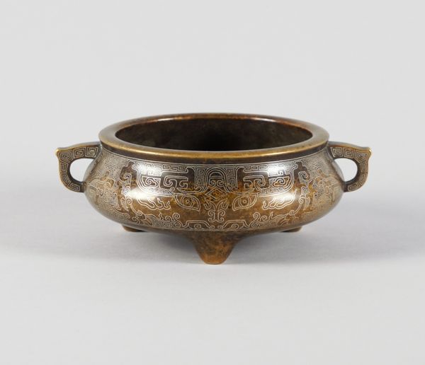 A CHINESE BRONZE TWO-HANNDLED TRIPOD CENSER