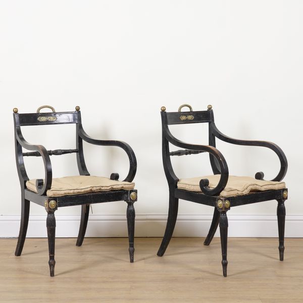 A PAIR OF REGENCY GILT METAL MOUNTED EBONISED OPEN ARMCHAIRS (2)