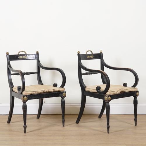 A PAIR OF REGENCY GILT METAL MOUNTED EBONISED OPEN ARMCHAIRS (2)