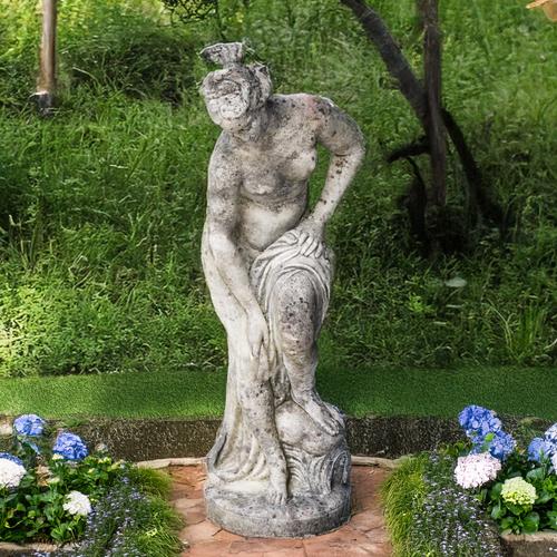 A RECONSTITUTED STONE FIGURE OF A BATHING WOMAN