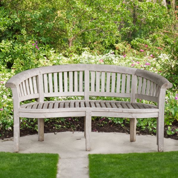 A TEAK CONCAVE GARDEN BENCH