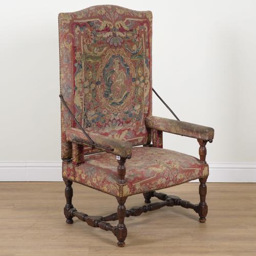 A WALNUT FRAMED TAPESTRY UPHOLSTERED RECLINING OPEN ARMCHAIR