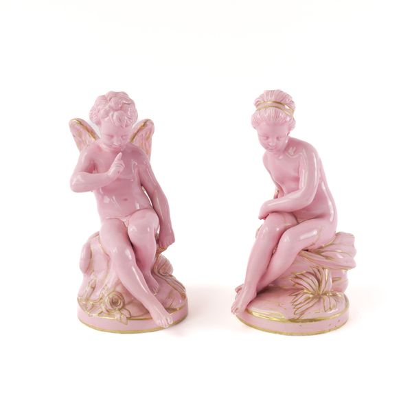 A PAIR OF SEVRES STYLE PINK GLAZED FIGURES OF CUPID AND PSYCHE (2)