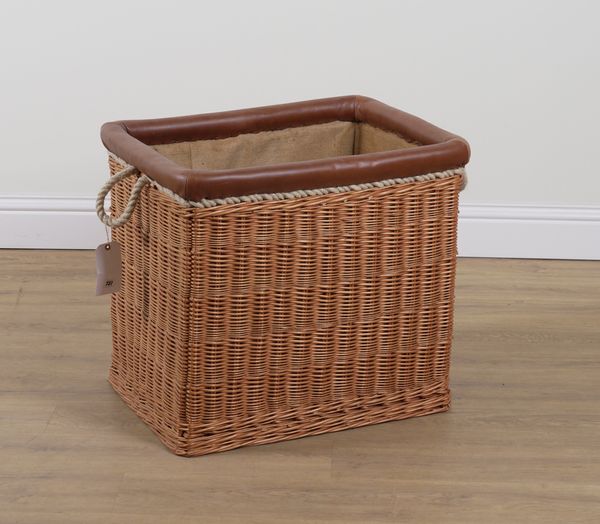 A RECTANGULAR WICKER LOG BASKET WITH LEATHER TRIM