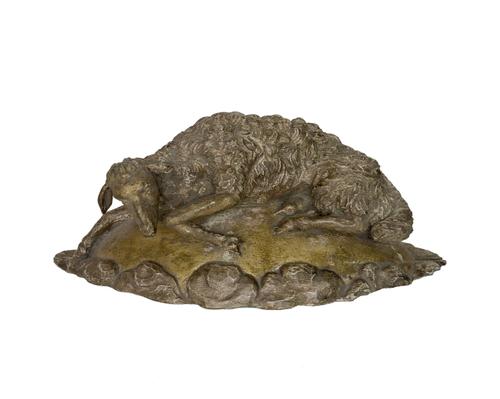 A BELIGIAN CARVED GILT AND PAINTED MODEL OF A RECLINING SHEEP OR ‘THE LAMB OF GOD’