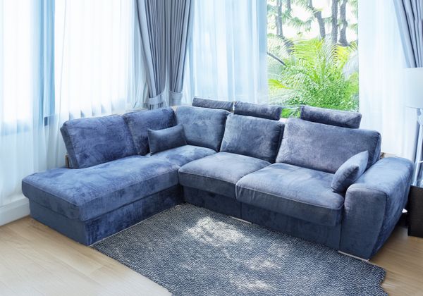 A BLUE VELVET CORNER SOFA