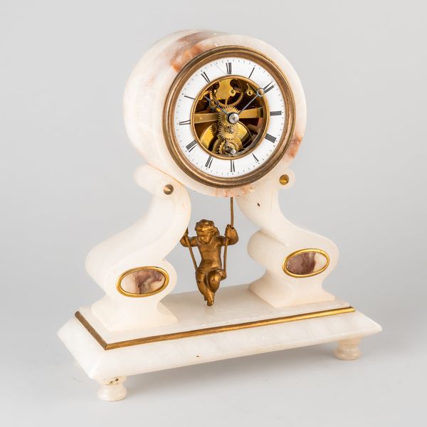 A RARE FRENCH GILTMETAL-MOUNTED ALABASTER ‘CHERUB ON A SWING’ BOUDOIR SKELETON TIMEPIECE