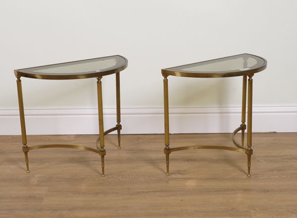 MAISON JANSEN; A PAIR OF 20TH CENTURY DEMI LUNE BRASS AND GLASS SIDE TABLES (2)