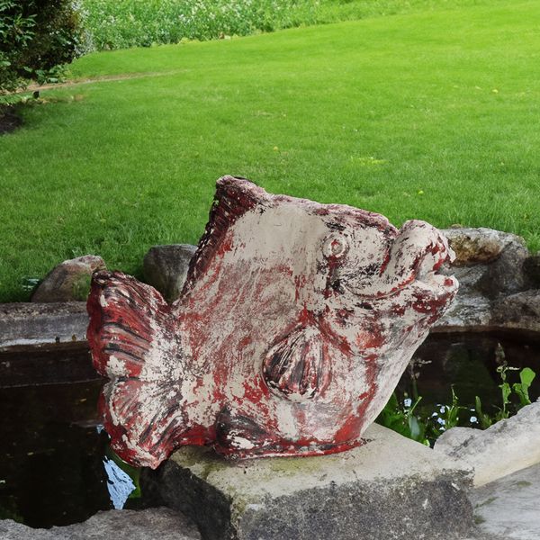 A PAINTED RECONSTITUTED STONE WATER FOUNTAIN FEATURE FORMED AS A FISH