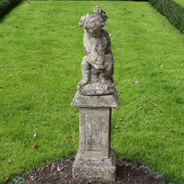 A RECONSTITUTED STONE WATER FOUNTAIN MODELED AS A CHERUB AND SEA SERPENT