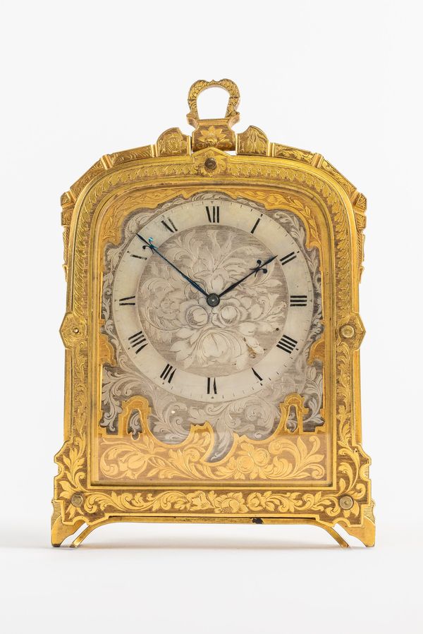 A VICTORIAN GILT BRASS ENGRAVED STRUT TIMEPIECE