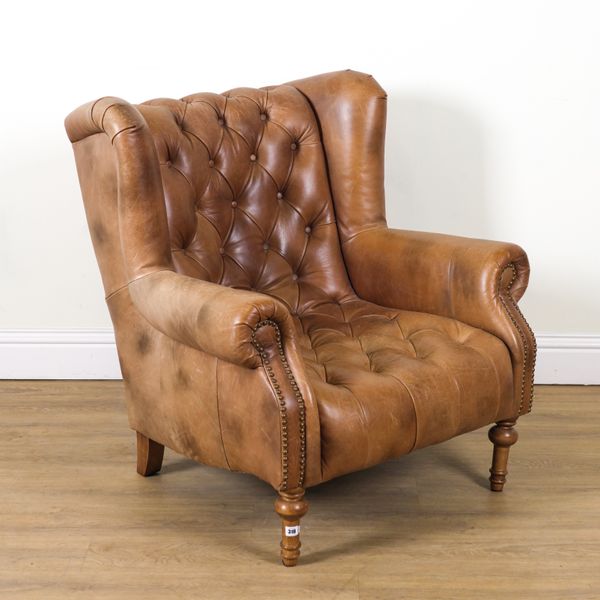 ALEXANDER AND JAMES; A 20TH CENTURY TAN LEATHER UPHOLSTERED WINGBACK EASY ARMCHAIR