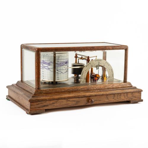 AN OAK AND GLAZED CASED BAROGRAPH