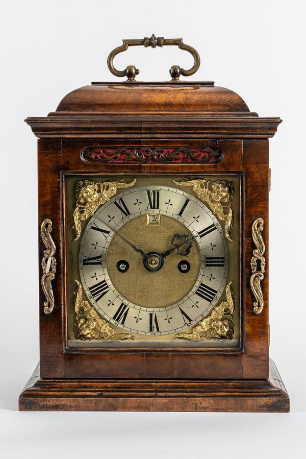 A WALNUT CASED TABLE CLOCK