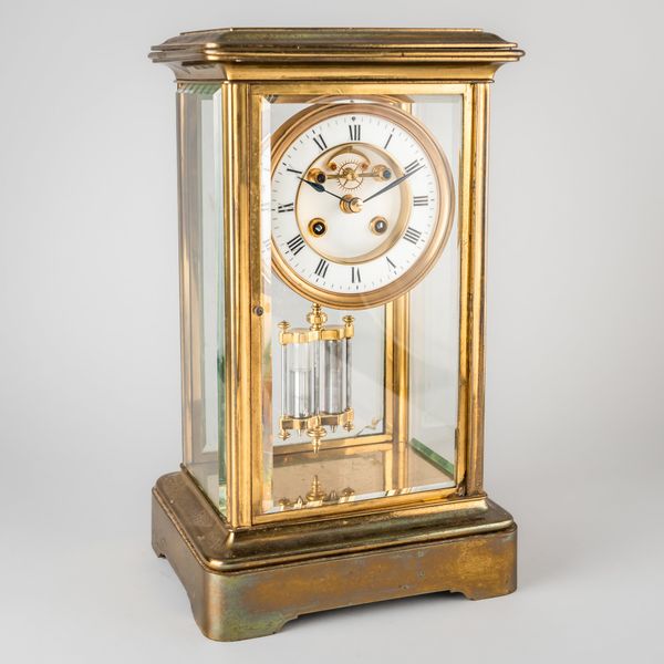 A FRENCH BRASS FOUR-GLASS MANTEL CLOCK