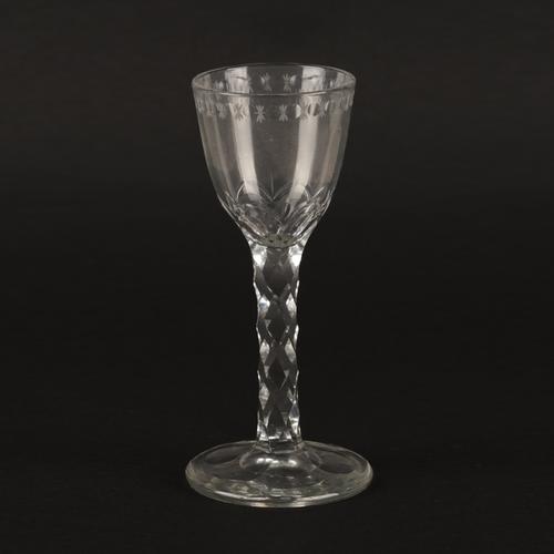 A FACET STEMMED WINE GLASS