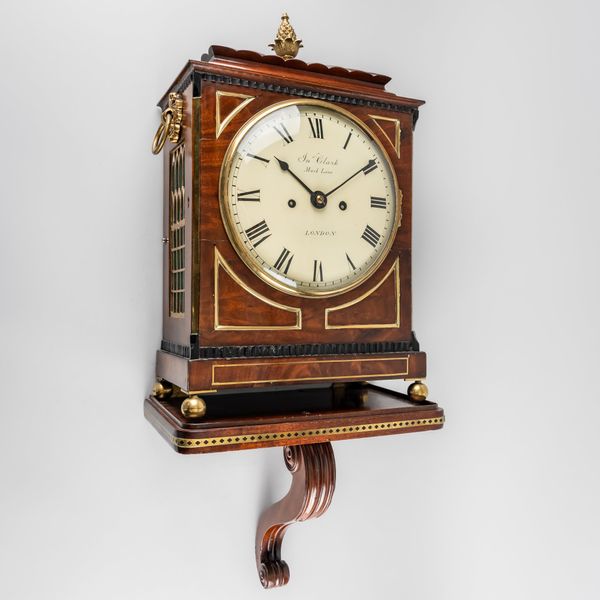 A REGENCY BRASS-MOUNTED MAHOGANY CHAMFER-TOP BRACKET CLOCK