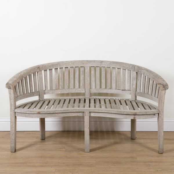 A 20TH CENTURY SLATTED HARDWOOD CONCAVE GARDEN BENCH