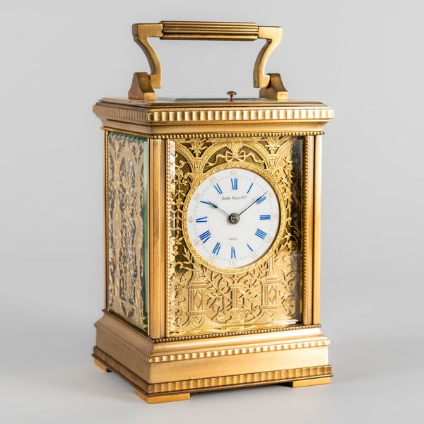 A FRENCH BRASS FILIGREE PANEL DECORATED STRIKING CARRIAGE CLOCK WITH PUSH/REPEAT