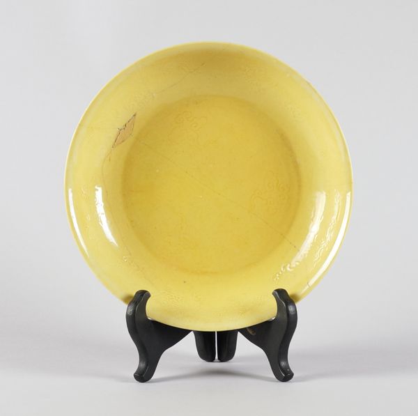 A CHINESE YELLOW GLAZED SAUCER DISH