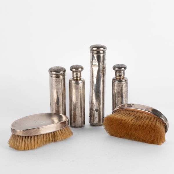 A set of four Edwardian silver dressing case items