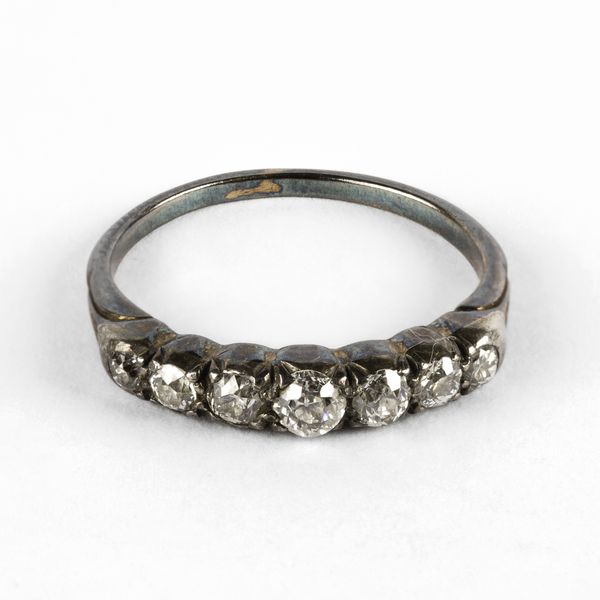 A white metal and diamond seven-stone ring