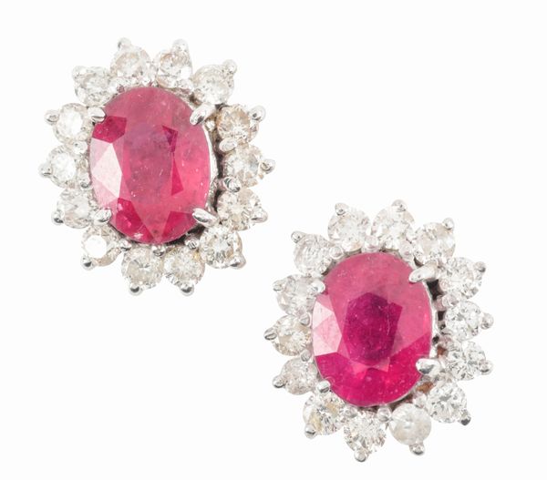 A PAIR OF GLASS FILLED RUBY AND DIAMOND STUD EARRINGS