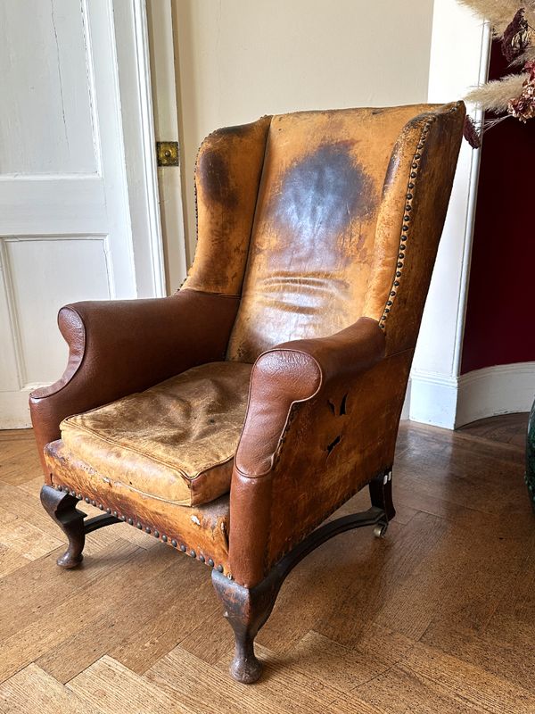 A MAHOGANY WINGBACK ARMCHAIR