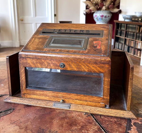 AN EDWARDIAN OAK LETTER BOX