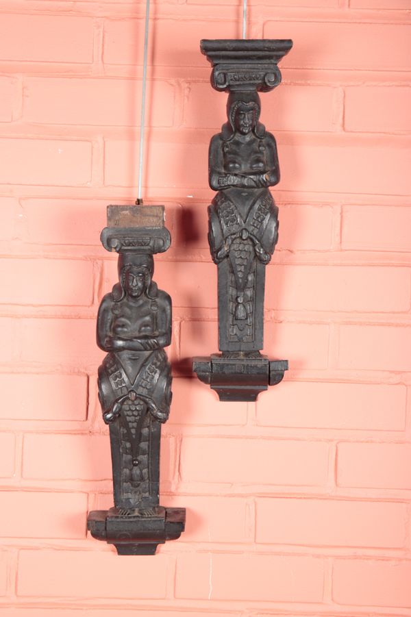 A PAIR OF BLACK-PAINTED OAK CARYATID TERMS