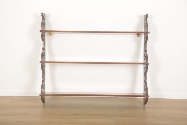 A MAHOGANY THREE TIER WALL SHELF OF GEORGIAN STYLE