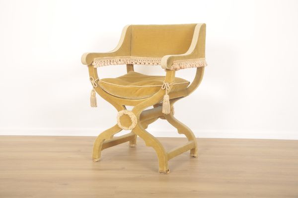 A SAVONAROLA CHAIR UPHOLSTERED IN DARK GOLD VELVET